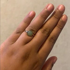 gold ring with light green gem